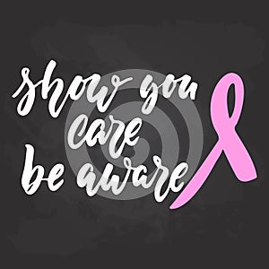 Show you care be aware - hand drawn October Breast Cancer Awareness Month lettering phrase on black chalkboard