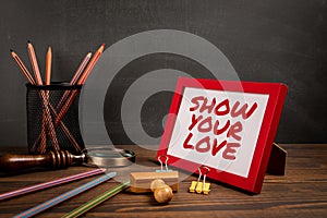Show Your Love. Text in picture frame. wood texture office desk