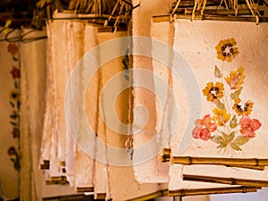 Showcase of Antemoro paper sheets, a flower embedded paper traditionally used to record secret knowledge, Ambalavao, Madagascar photo