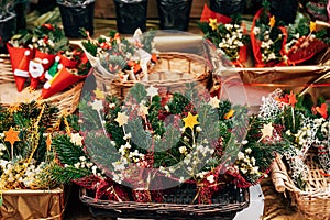 Showcase of bunch of holly the Christmas market. Envelopes with christmas tree branch, bump, berries, stars. New Year`s