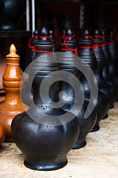 Showcase with clay pots from handmade jugs. Asian traditional jugs