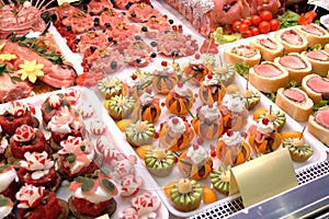 A showcase of a delicatessen with ready-made snacks of meat, fruit and vegetables