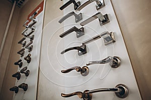 Showcase with door handles in modern shop of doors hardware