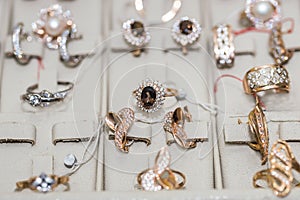 Showcase of jewellery store with earrings and rings close up