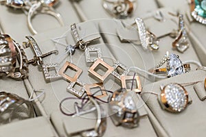 Showcase of jewellery store with earrings and rings close up