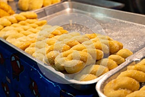 A showcase with pastries, rolls with colored fillers