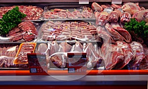 Showcase with raw meat in butcher shop