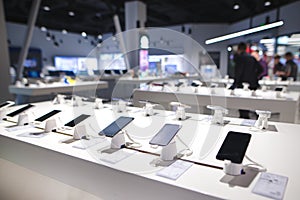 Showcase with smartphones in the modern electronics store. Many smartphones on the shelf of the technology store