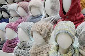 Showcase of trade tent with a variety of women`s hats for the autumn and winter seasons