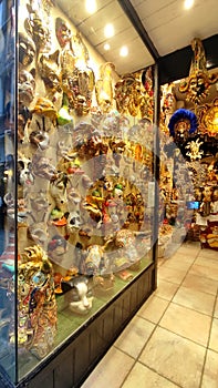 A showcase with Venetian masks, expensive carnival decorations, a souvenir from Venice