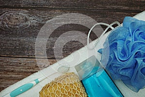 Shower accessories bath items shower gel, sponge, Hair Brush, fibre scrub on wooden background