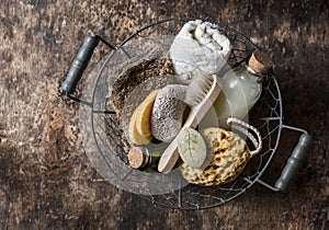 Shower accessories in vintage basket - shampoo, sponge, soap, facial brush, towel, washcloth, pumice stone. Natural beauty care pr