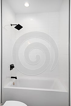 A shower and bathtub with white subway tiles.