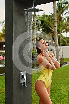 Shower On Beach. Woman In Swimsuit Showering At Pool Shower.
