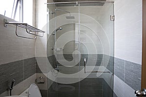 Shower cabin with a glass walls and door in a modern bathroom.