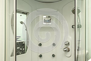 Shower cabin with radio and pressurized water jets