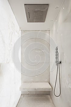 Shower covered in white marble, design photo