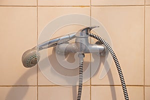 shower faucet with a watering head on a long hose in the bathroom, shower cabin