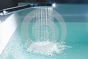 Shower filling a bathtub with water stream