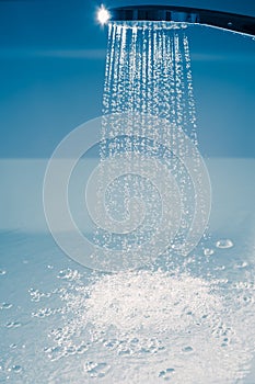 Shower filling a bathtub with water stream