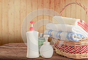 Shower gel with Skin cream and bath towels in basket