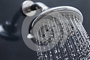 Shower head in bathroom with water drops