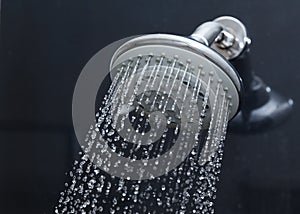 Shower head in bathroom with water drops