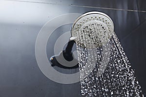 Shower head in bathroom with water drops