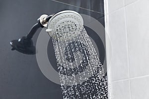 Shower head in bathroom with water drops