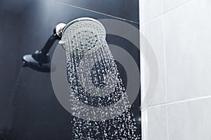 Shower head in bathroom with water drops