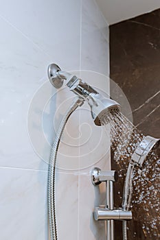 shower head in bathroom with water drops flowing