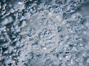 Shower head with flow of water spilling out closeup.
