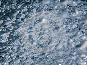 Shower head with flow of water spilling out closeup.