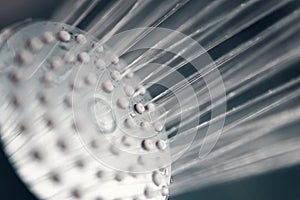 Shower head with flow of water spilling out closeup.