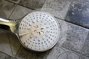 Shower head with limescale close-up.