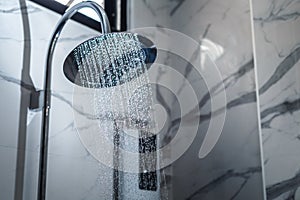 [shower head] shower head in bathroom with water drops flowing