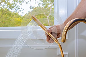 Shower head with stream water in domestic bathroom