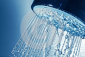 Shower Head with Water Stream on Blue Background