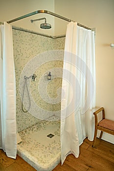 Shower room with curtains and mosaics.