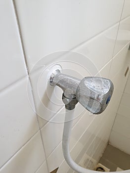 Shower tap chrome in white bathroom