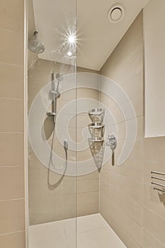 a shower with two showerheads and a glass door