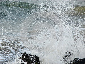 Shower of Water Droplets due to Sea Waves Crashing on Rocks