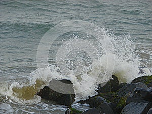 Shower of Water Droplets due to Sea Waves Crashing on Rocks