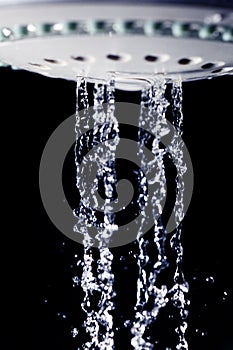 Shower water drops on black background