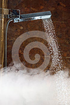 Shower with water stream and hot steam photo