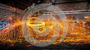 Showers of hot glowing sparks from spinning steel wool