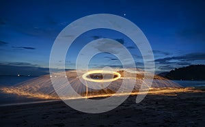 Showers of hot glowing sparks from spinning steel wool.