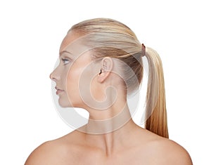 Showing the benefits of great beauty treatments. A beautiful young blonde woman posing in front of a white background.