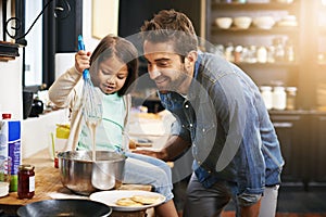 Showing dad a thing or two about cooking. a father and daughter making pancakes together.