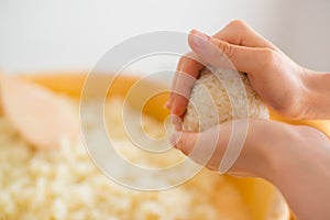 Showing how to make Rice Ball ``Onigiri`` is a typical meal in Japan. Japanese people grab some rice into balls with a shape o